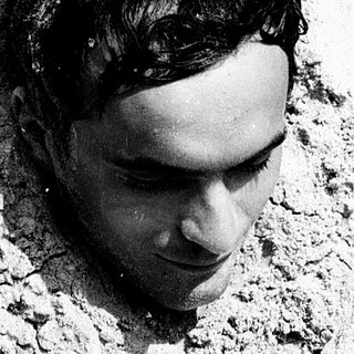 Person lying on cracked, dry ground.