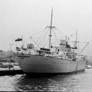 Vintage passenger ship named "Eduardo de Medina" docked.