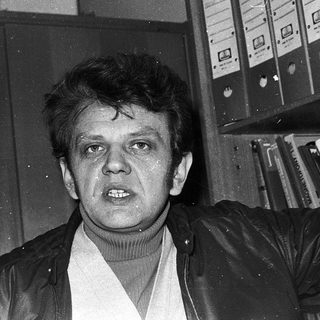 Young man in turtleneck and leather jacket.