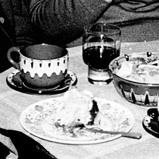 Three elderly people enjoying a meal together indoors.