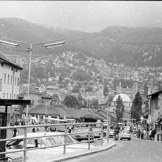 Mountain town street with historic buildings and cars.