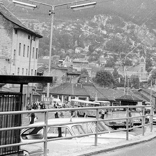 Mountain town street with historic buildings and cars.