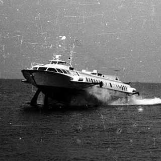 High-speed boat cutting through choppy, rainy seas.