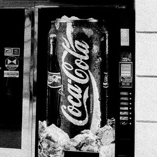 Entrance to "U Dobrého Kata" café with Coca-Cola vending machine.