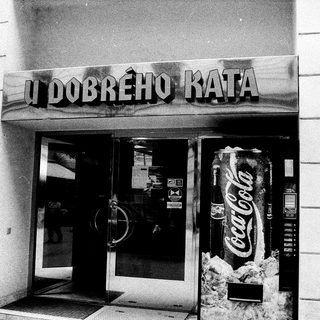 Entrance to "U Dobrého Kata" café with Coca-Cola vending machine.