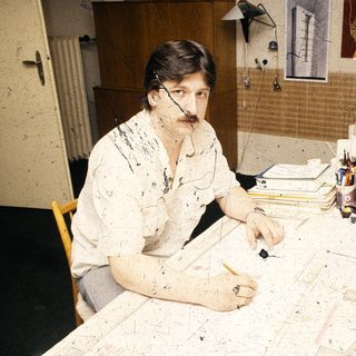 Artist working on large-scale abstract painting.