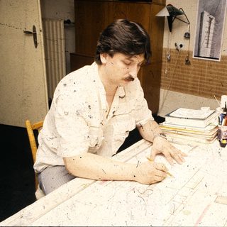 Artist working on large-scale abstract painting.