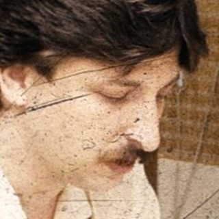 Person working on detailed craft or drawing project.
