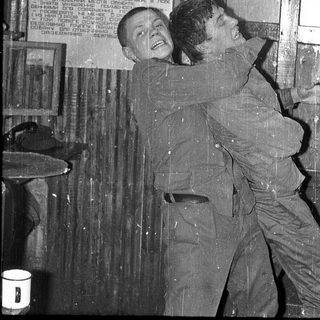 Two men playing prank with poster.