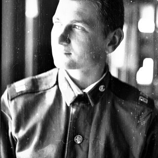 Young man in early 20th-century military uniform.