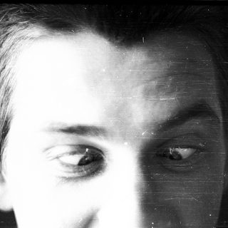Close-up black-and-white portrait of a man.