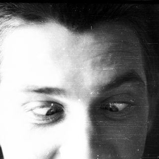 Close-up black-and-white portrait of a man.