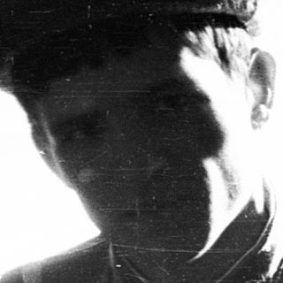 Two soldiers in vintage military uniforms, taken through a window.