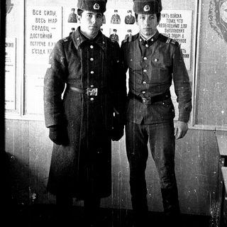 Two young men in Soviet military uniforms, posing for a photo.