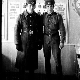 Two young Soviet soldiers in uniform pose together.