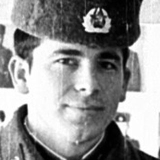 Two young Soviet soldiers in uniform pose together.