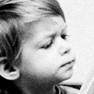 A young child engrossed in reading a book.
