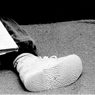Young child engrossed in reading book.
