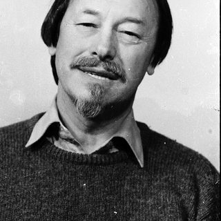 Man with mustache and beard smiling.