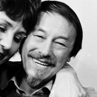 Joyful couple sharing a tender moment indoors.