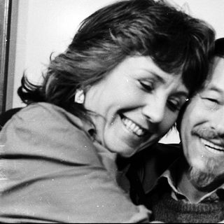 Joyful couple sharing a tender moment indoors.