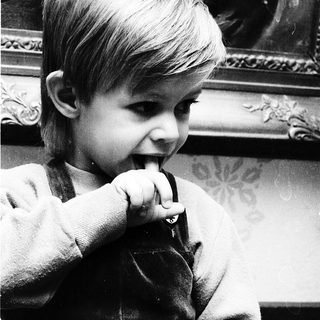 Young child brushing teeth indoors.