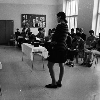 Classroom setting with instructor teaching seated students.