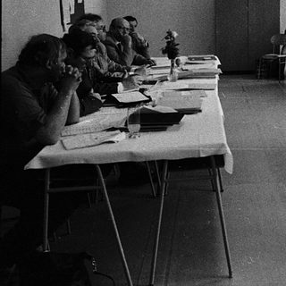 Classroom setting with instructor teaching seated students.