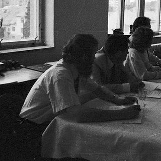 Classroom setting with students writing at desks.