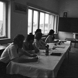 Classroom setting with students writing at desks.