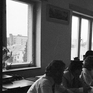 Classroom setting with students writing at desks.