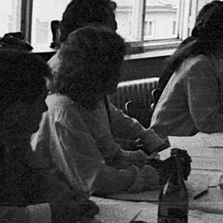 Classroom setting with students writing at desks.