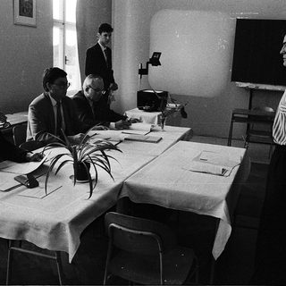 Business meeting or conference in formal attire.