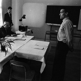 Business meeting or conference in formal attire.