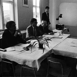 Business meeting or conference in formal attire.