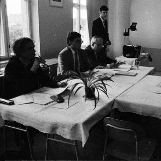 Business meeting or conference in formal attire.