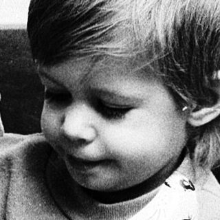 Child playing with large stuffed animal doll.