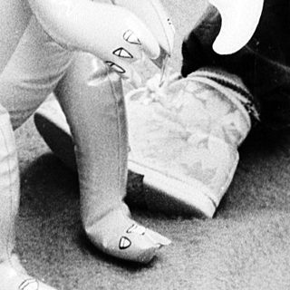 Young child playing with dinosaur toys.