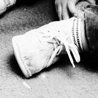 Young child playing with doll indoors.