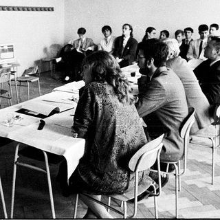 Classroom lecture with students using early computers.