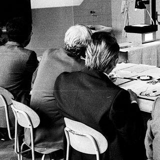 Classroom lecture with vintage computer demonstration.