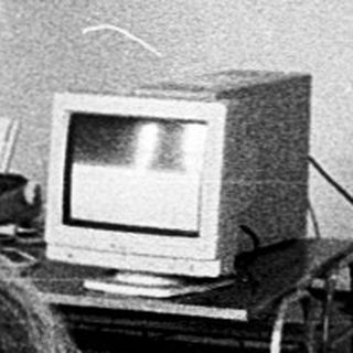 Classroom lecture with vintage computer demonstration.