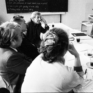 Business meeting with group discussing documents.