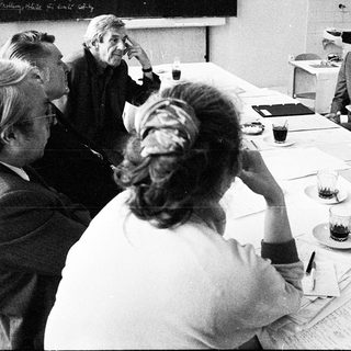 Business meeting with group discussing documents.