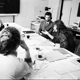 Business meeting with group discussing documents.