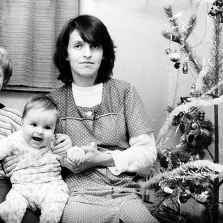 Family portrait with mother, toddler, and young boy.