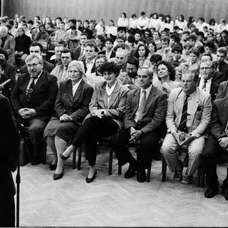 Formal audience listening to a speaker.