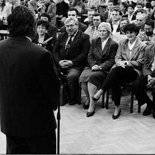 Formal audience listening to a speaker.