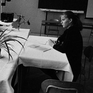 Four people engaged in a formal meeting or discussion.