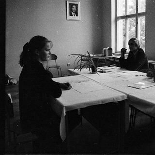 Four women studying or working together indoors.